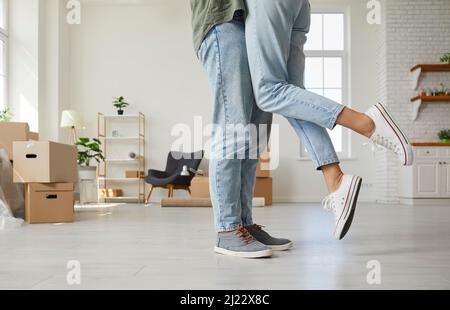 Eine kurze Aufnahme eines verliebten glücklichen Paares, das in seiner neuen Wohnung oder in seinem Haus steht und sich küsst Stockfoto