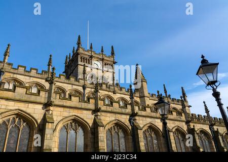 All Saints' Church, auch bekannt als Wigan Parish Church, mit blauem Himmel dahinter. Ursprünglich erbaut im 13.. Jahrhundert mit Ergänzungen in den 16. und 17t Stockfoto