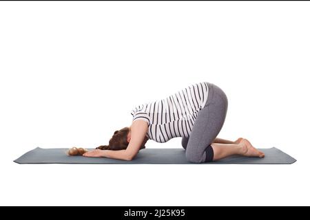 Schwanger Frau macht Yoga Asana Balasana Kind Pose Stockfoto