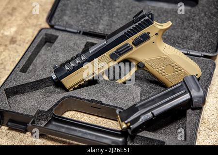 Moderne traumatische Pistole. Nicht-tödliche Kurzwaffen-Waffe zur Selbstverteidigung. Heller Hintergrund. Stockfoto