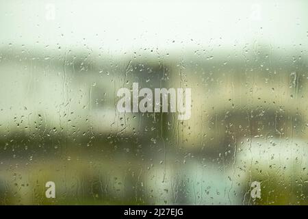 Blick auf Regentropfen auf der Fensterscheibe mit Blick aus einer Wohnung. Schweden. Stockfoto