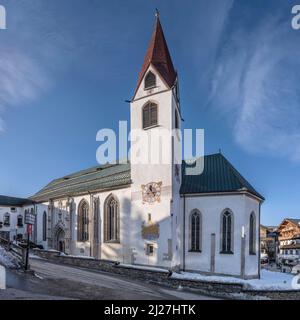Stadtbild mit historischer St. Osvald parrish Kirche in touristischer Vollzeit, aufgenommen im hellen Winterlicht bei Seefeld, Tirol, Österreich, Stockfoto