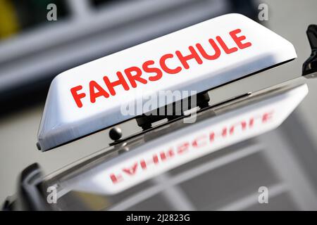 30. März 2022, Niedersachsen, Göttingen: Ein Dachschild mit der Aufschrift „Fahrschule“ ist an einem fahrenden Schulwagen angebracht. Foto: Swen Pförtner/dpa Stockfoto