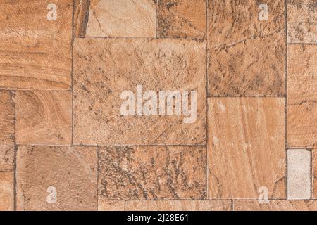 Braune Bodenfliese mit abstraktem Stein quadratischem Muster Oberflächenstruktur Hintergrund. Stockfoto