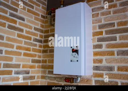 Warmwasserbereitung mit Temperaturregelung. Elektrischer Boiler mit Wassereinlass und -Auslass. Der Kessel für die Warmwasserbereitung wird in einem Wohngebäude verwendet Stockfoto