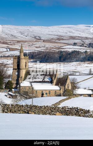 Wetter - 31. März 2022 - Hawes, North Yorkshire, UK. Die Kirche der Heiligen Margarete von Antiochia in Hawes hebt sich von der winterlichen Landschaft in Hawes, Wensleydale, ab, als über Nacht eine Schneedecke in die Gegend fiel. Quelle: Wayne HUTCHINSON/Alamy Live News Stockfoto