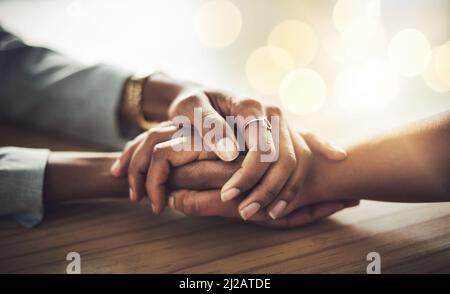 Ihr könnt mir alles sagen. Nahaufnahme von zwei Frauen, die sich die Hände halten. Stockfoto