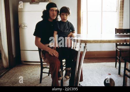 Ein junger Mann mit seinem jüngeren Bruder im Essbereich ihres neuen Hauses ca. 1975 Stockfoto