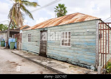 Kleines Haus mit verwitterter Fassade und rostigen Dach in den Vororten von Willemstad, Curacao Stockfoto