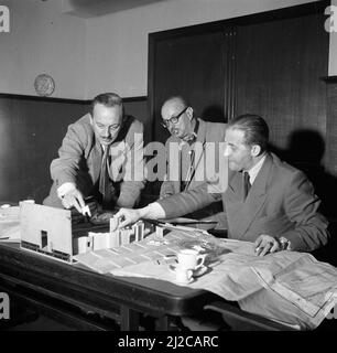 Regisseur Gerard Rutten und Produzent Bobby Roosenboom überprüfen ein Model im Cinetone-Omo Studio Ca. 10. Dezember 1953 Stockfoto