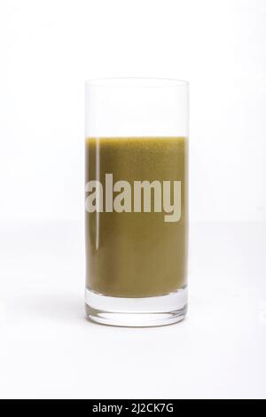 Grüner Smoothie in einem Glas auf weißem Hintergrund. Stockfoto