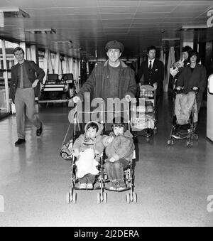 Der amerikanische Filmstar Dustin Hoffman und seine Frau Lisa mit ihren Kindern Jake im Alter von 3 Jahren, Rebecca im Alter von 1 Jahren und dem Baby Max verlassen den Flughafen Heathrow nach New York auf der Concorde. 9.. Januar 1985. Stockfoto