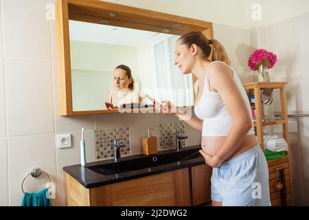 Schwanger Frau in Schmerzen berühren Bauch rufen Arzt Stockfoto