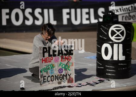 Edinburgh, Schottland, 1. April 2022. Klimaaktivisten vom Aussterben Rebellion protestieren vor dem schottischen Parlament am Tag der Rekordanstiege der Energiepreise in Großbritannien. Aktivisten, von denen einer eine Maske des russischen Präsidenten Wladimir Putin trug, inszenierten vor dem Gebäude einen Ölpest, um gegen die anhaltende Abhängigkeit von fossilen Brennstoffen zu protestieren. Foto: Jeremy Sutton-Hibbert/Alamy Live News. Stockfoto