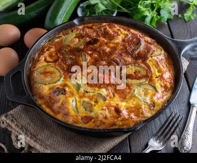 Frittata mit mediterranem Gemüse. Gekocht mit Zucchini, roten Zwiebeln, Paprika. Stockfoto