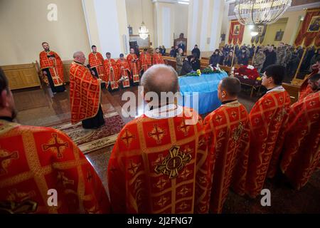 Nicht exklusiv: MUKACHEVO, UKRAINE - 1. APRIL 2022 - Priester stehen am Sarg des 18-jährigen Viktor Karytschak, einem Soldaten des mechanisierten Bataillons Stockfoto