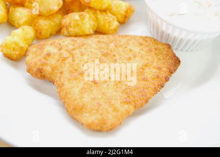 Panierter Haddock-Fisch als Teil eines schnellen Abendessens Stockfoto