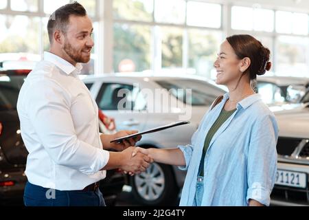 Nun, auf jeden Fall finden Sie das Auto, das Sie wollen. Aufnahme eines Geschäftsmannes, der mit seinem Kunden die Hände schüttelt. Stockfoto