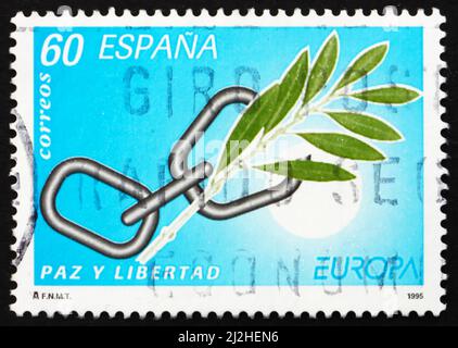 SPANIEN - UM 1995: Eine in Spanien gedruckte Marke zeigt Broken Chain und Olive Branch, um 1995 Stockfoto