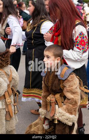 Bulgarischer Junge auf dem mystischen traditionellen tausendjährigen Winterfest Kukeri in Sofia, Bulgarien, Balkan, Osteuropa. Kukeri ist eine jahrhundertealte Tradition, die böse Geister vertreiben und gute einladen soll, die um den frühen Winter oder die Wintermitte abgehalten wird. Stockfoto