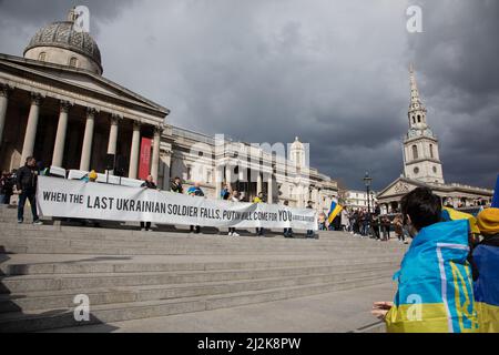 London, Großbritannien. 2. April 2022. Auf dem Trafalgar Square wird ein Transparent hochgehalten, wo sich die Menschen versammelt haben, um Solidarität mit der Ukraine zu zeigen und ein Ende des Krieges zu fordern. Quelle: Kiki Streitberger/Alamy Live News Stockfoto