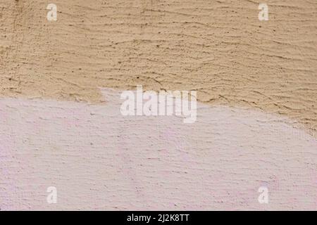 Die farbige Wand ist zwei Farben: Senf beige rosa Flieder abstrakten Farbe Hintergrunddesign. Stockfoto