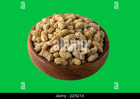 Schüssel voll getrockneter Maulbeere auf grünem Hintergrund Stockfoto