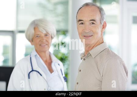 Arzt, der zu Hause einen behinderten älteren Patienten besucht Stockfoto