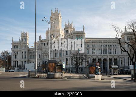 Blick auf die Plaza de Cibeles mit leeren Bushaltestellen und den Palast von Cibeles (Palacio de Cibeles), ein Komplex aus zwei Gebäuden mit weißen Fassaden. Stockfoto