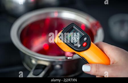 Der Prozess der Herstellung von Fruchtgelee auf einem Induktionsherd. Stockfoto