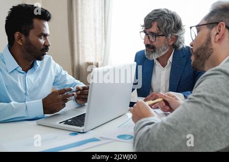 Multi-ethnische Geschäftsleute arbeiten zusammen innerhalb der Bank Büro - Fokus auf indischen Mann Gesicht Stockfoto