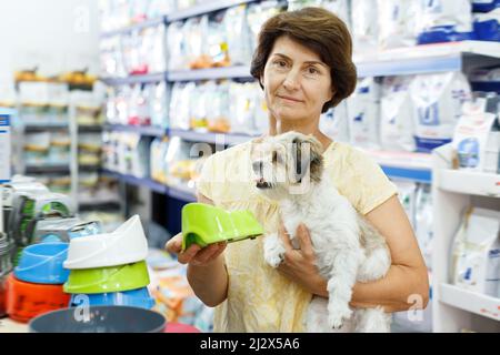 Gewöhnliche Frau besuchen Pet Shop auf der Suche nach Dog Bowl für die Fütterung Ihres süssen Havaneser Stockfoto