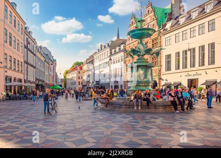 Viele Menschen gehen und sitzen in der Nähe des Storchbrunnens auf dem Amager Platz Amagertorv in der Fußgängerzone von Strøget. Kopenhagen, Dänemark Stockfoto