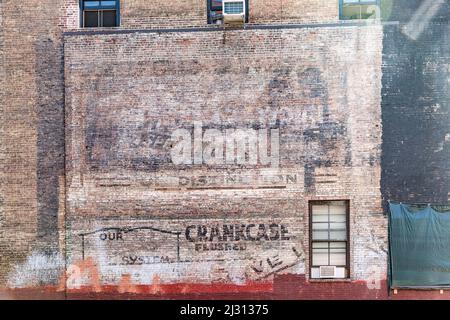 NEW YORK, USA - Okt 5, 2017: Alte gemalte Ziegelwand mit alter Werbung verschiedener Marken in schlechtem Zustand. Die Anzeigen stammen aus dem frühen 20th. Jahrhundert Stockfoto