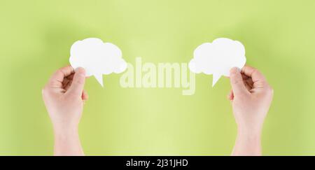 Eine weiße Cloud in der Hand halten, leere Textfläche für Text, grünen Hintergrund, Kommunikations- und Marketingkonzept, vernetzt sein, vernetzen Stockfoto