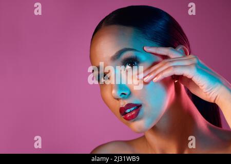 Shes hat den Look. Beschnittene Aufnahme einer attraktiven jungen Frau, die im Studio vor einem rosa Hintergrund posiert. Stockfoto