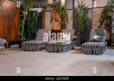 Leere Liegestühle im Spa-Center vor dem Hintergrund des dekorierten Zimmers Stockfoto