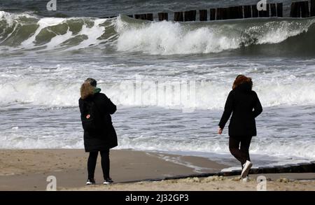 05. April 2022, Mecklenburg-Vorpommern, Kühlungsborn: Wanderer sind auf der aufwühlenden Ostsee in Sonne und Wind unterwegs. Foto: Bernd Wüstneck/dpa Stockfoto