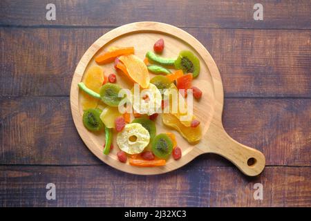 Dried fruits and berries on a wooden board on table  Stockfoto