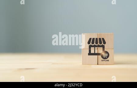 Offline-Shopping und Offline-Marketing-Konzept. Die Holzwürfel mit Shop- und Offline-Kauf-Icons auf grauem Hintergrund und Kopierfläche. Marketing A Stockfoto