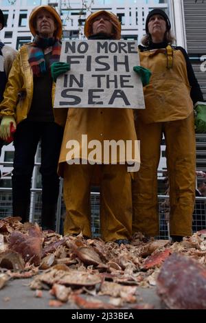 London, Großbritannien. 5. April 2022. Mitglieder von Ocean Rebellion, führen bei der DEFRA eine kreative Theateraktion durch, als Reaktion auf George Eusticles Vertuschung der Nordsee, die durch die Entsorgung von giftigem Schlamm auf See verursacht wurde, Mitglieder der Ocean Rebellion, die als Fisher People verkleidet sind, werden Kisten mit echten toten Krabben mitbringen, um einen Berg giftiger Abfälle für die DEFRA zur Untersuchung zu hinterlassen. Nach diesem Dumping werden Ermittler für Klimakriminalität am Tatort teilnehmen, um es abzudichten, zu untersuchen und Beweise zu entfernen. Kredit: Joao Daniel Pereira Gutschrift: Joao Daniel Pereira/Alamy Live Nachrichten Stockfoto