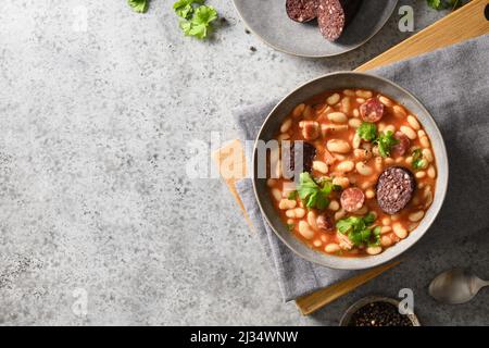 Asturiana traditionelle Fabada mit Haricot, Blutwurst serviert frischen knusprigen Toast auf grauen Stein Tisch. Blick von oben. Speicherplatz kopieren. Spanische Küche. Stockfoto