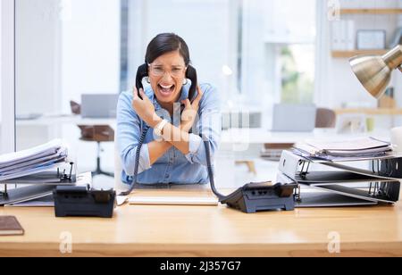 Ich brauche eine Pause, das ist zu viel. Aufnahme einer jungen Geschäftsfrau, die vor Frustration an ihrem Telefon schreit. Stockfoto