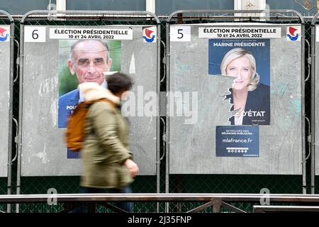 Paris, Frankreich, 5. April 2022, Ein Fußgänger passiert ein offizielles Wahlkampfplakat des rechtsextremen Kandidaten Eric Zemmour (Reconquete) und des von Marine Le Pen (Rassemblement National) auf einer Wahlplakatwand (Schild). Präsidentschaftsplakate auf ihren Wahlvorständen. Abbildung am 5. April 2022 in Paris, Frankreich. Die französischen Wähler kommen am 10. April 2022 zur Wahl für die erste Runde der Präsidentschaftswahlen, um ihren neuen Präsidenten der Republik zu wählen. Foto von Victor Joly/ABACAPRESS.COM Stockfoto