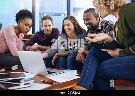 Arbeiten an Möglichkeiten, ihre besten Konzepte zum Leben zu erwecken. Eine kurze Aufnahme eines Teams von Designern, die im Büro zusammenarbeiten. Stockfoto