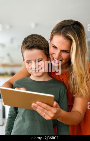 Mutter und Kind verwenden digitales Tablet zum E-Learning. Bildung zu Hause digitale Gerät KID-Konzept. Stockfoto