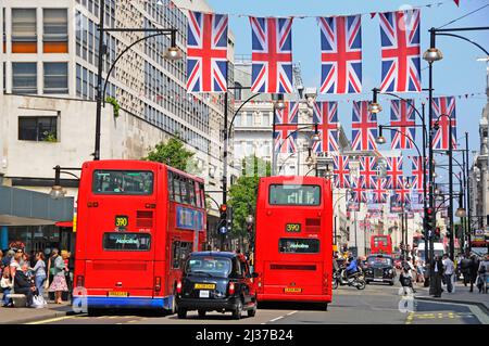 Oxford Street Scene London Union Jack Flag Display für Queens Jubilee & 2012 Olympics Feiern zwei rote Doppeldeckerbusse & schwarzes Taxi England UK Stockfoto