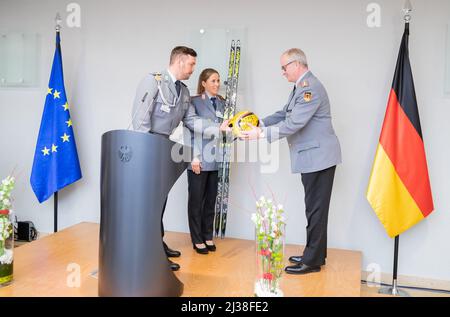 Berlin, Deutschland. 06. April 2022. Tobias Wendl (l-r), Rodelsportlerin, und Katharina Hennig, Langlauffahrerin, präsentieren Eberhard Zorn, Generalinspekteur der Bundeswehr, mit Skiern und Helm bei der Verleihung der Bundeswehr-Athleten, die an den Olympischen Winterspielen 2022 und den Paralympics 2022 in Peking teilgenommen haben. Quelle: Christoph Soeder/dpa/Alamy Live News Stockfoto