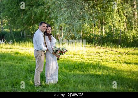 Junge Hochzeitspaar - frisch vermählten Bräutigam und Braut posiert im Freien auf ihre Hochzeit Tag Farbe getönten Bild. Stockfoto