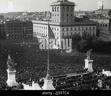 Multitude jubelt über Duces Kriegsdekret -- die Menge, die Premier Benito Mussolini jubelte, als er am 10. Juni vom Balkon des Palazzo Venezia in Rom verkündete, Italien habe Großbritannien und Frankreich den Krieg erklärt. Andere Scharen versammelten sich auf Plätzen im ganzen Land und hörten die Erklärung von lauten Lautsprechern. „Wir gehen auf Schlachtfelder gegen plutokratische reaktionäre Demokratien, erklärte Duce. 21. Juni 1940. (Foto von Associated Press-Paramount News Photo). Stockfoto